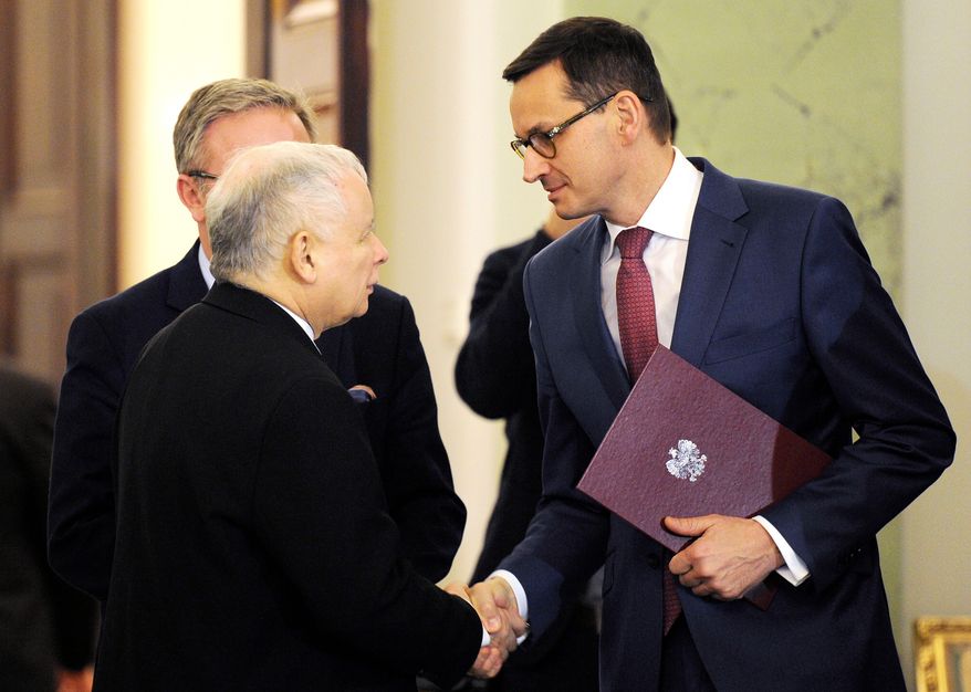 Newly designated for the prime minister's post Mateusz Morawiecki, right, is congratulated by Jaroslaw Kaczynski, left, leader of Poland's ruling conservative party Law and Justice, in Warsaw, Poland, Friday, Dec. 8, 2017. (AP Photo/Alik Keplicz, File)
