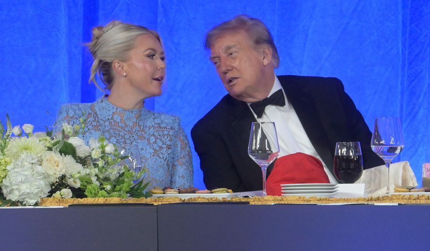 President Donald Trump talks with White House press secretary Karoline Leavitt at the White House Correspondents' Association dinner at the Waldorf Astoria Washington DC, Friday, July 24, 2026, in Washington. (AP Photo/Rod Lamkey, Jr.)