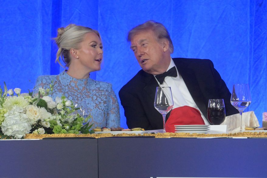 President Donald Trump talks with White House press secretary Karoline Leavitt at the White House Correspondents' Association dinner at the Waldorf Astoria Washington DC, Friday, July 24, 2026, in Washington. (AP Photo/Rod Lamkey, Jr.)