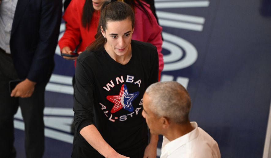 Former President Barack Obama shakes hands with WNBA All-Star Caitlin Clark during a practice at the Obama Presidential Center in Chicago, Friday, July 24, 2026. (AP Photo/Paul Beaty)