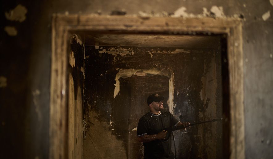 A Palestinian man cleans a room of a house damaged following an attack by Israeli settlers the previous day in the village of Sarra, near the West Bank city of Nablus, Saturday, July 25, 2026. (AP Photo/Leo Correa)