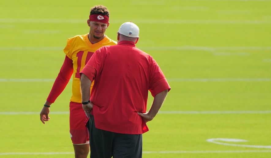 Kansas City Chiefs quarterback Patrick Mahomes talks with head coach Andy Reid at NFL football training camp Saturday, July 25, 2026, in St. Joseph, Mo. (AP Photo/Charlie Riedel)