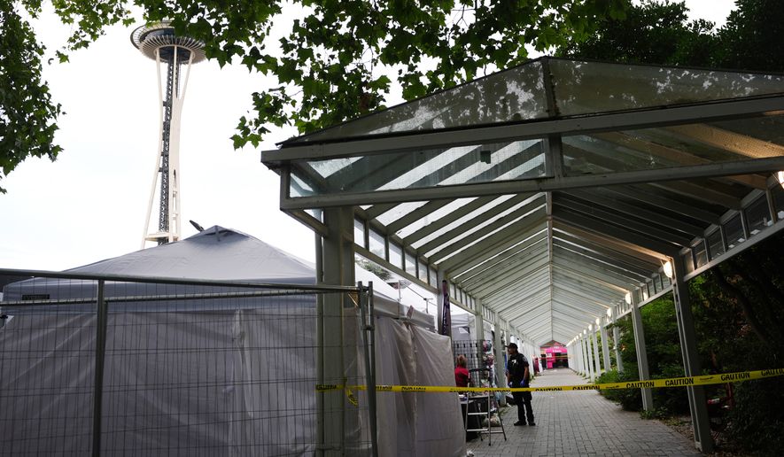 Police respond to a shooting at Seattle Center during the Bite of Seattle food festival Sunday, July 26, 2026, in Seattle, Wash. (AP Photo/Lindsey Wasson)
