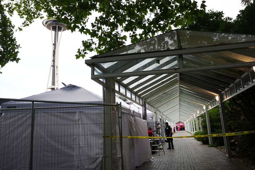 Police respond to a shooting at Seattle Center during the Bite of Seattle food festival Sunday, July 26, 2026, in Seattle, Wash. (AP Photo/Lindsey Wasson)