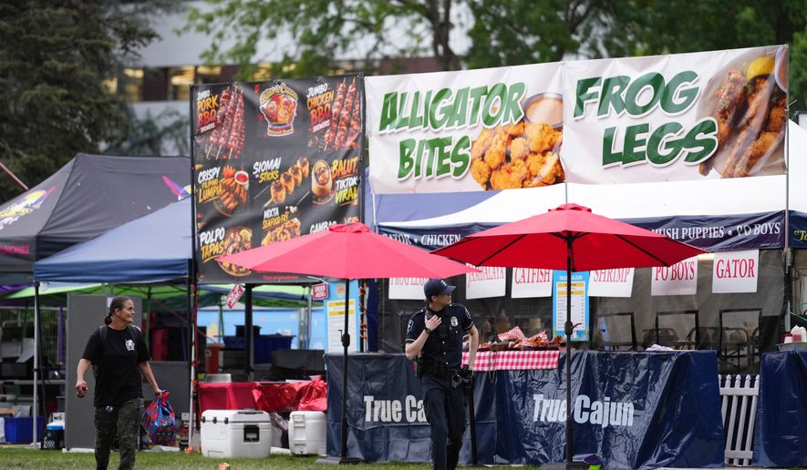Police respond to a shooting at Seattle Center during the Bite of Seattle food festival Sunday, July 26, 2026, in Seattle, Wash. (AP Photo/Lindsey Wasson)