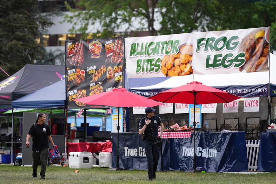 Police respond to a shooting at Seattle Center during the Bite of Seattle food festival Sunday, July 26, 2026, in Seattle, Wash. (AP Photo/Lindsey Wasson)