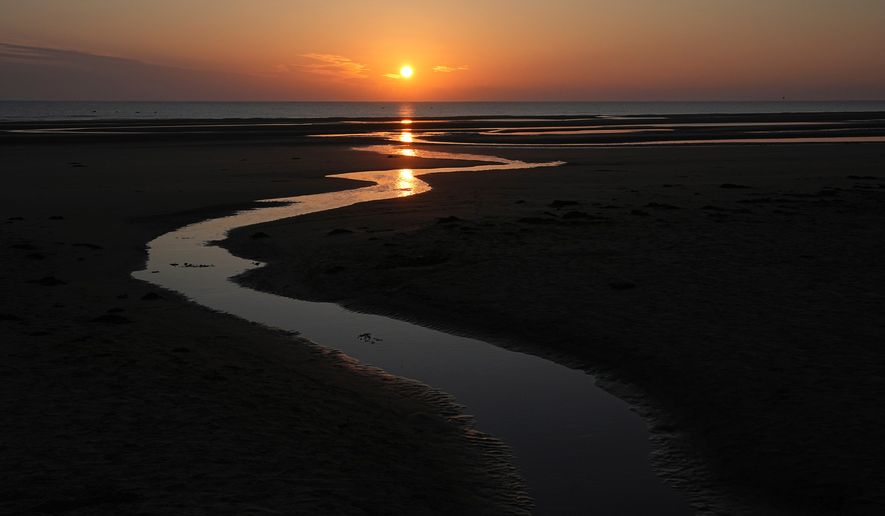 FILE - Sun rises over Omaha Beach near Colleville-sur-Mer Normandy, Thursday, June 6, 2024. (AP Photo/Laurent Cipriani, file)