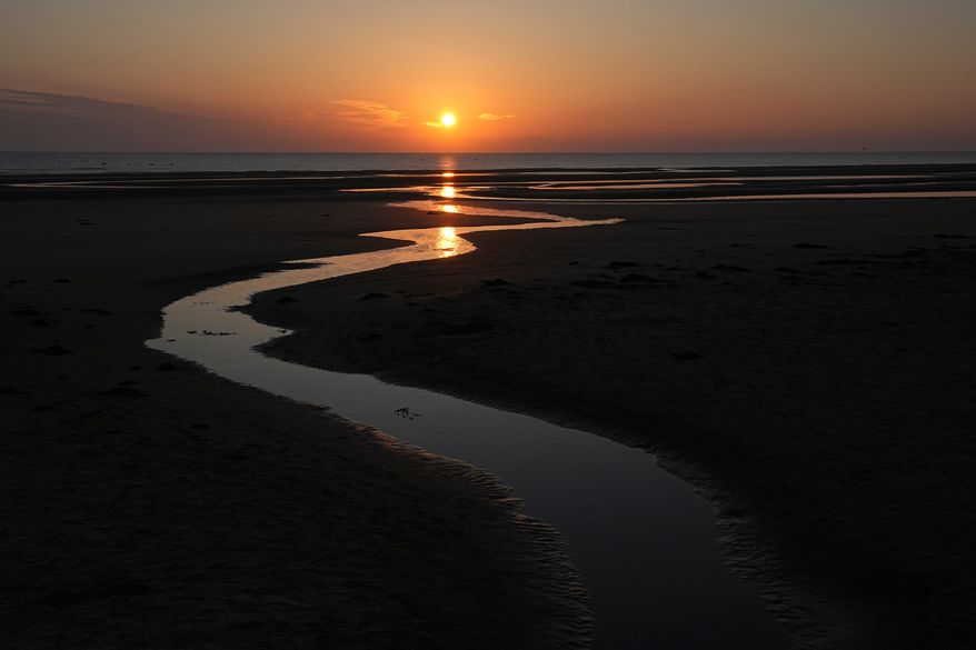 FILE - Sun rises over Omaha Beach near Colleville-sur-Mer Normandy, Thursday, June 6, 2024. (AP Photo/Laurent Cipriani, file)