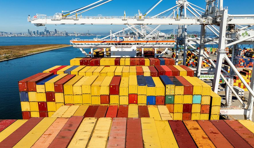 FILE - Cargo containers line a ship at the Port of Oakland on Wednesday, Aug. 6, 2025, in Oakland, Calif. (AP Photo/Noah Berger, File)