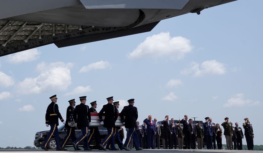 President Donald Trump and Secretary of Defense Pete Hegseth and others, salute as a U.S. Army carry team moves a transfer case containing the remains of Sgt. Angel S. Rampersad, of Ozone Park, N.Y. Wednesday, July 22, 2026, at Dover Air Force Base, Del. (AP Photo/Matt Rourke)