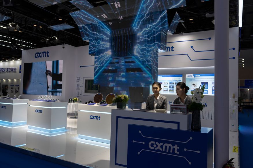 Workers at the booth for Chinese DRAM producer ChangXin Memory Technologies, also known as CXMT, wait for visitors at the 21st China International Semiconductor Expo in Beijing, Nov. 20, 2024. (AP Photo/Ng Han Guan, File)