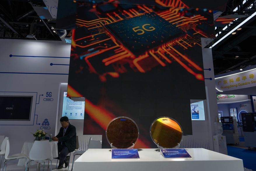 A man rests at the booth for Chinese DRAM producer ChangXin Memory Technologies, also known as CXMT, during the 21st China International Semiconductor Expo in Beijing, Nov. 20, 2024. (AP Photo/Ng Han Guan, File)