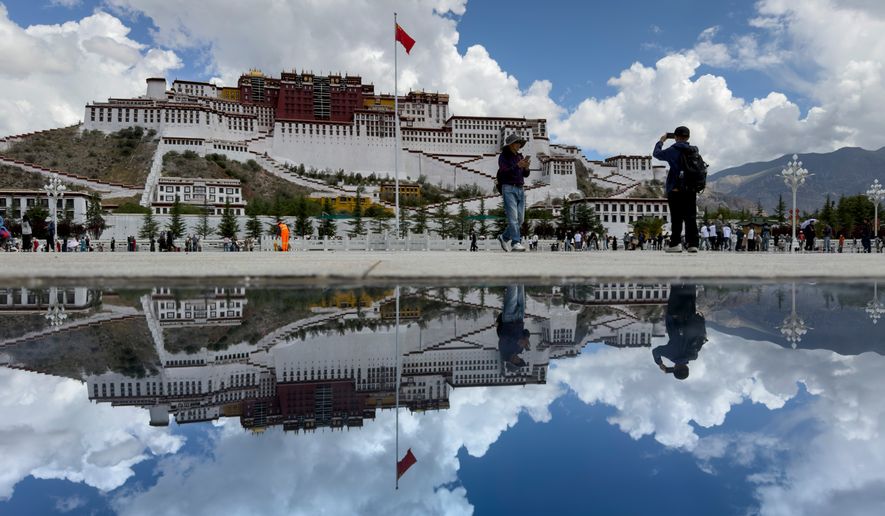 The Potala Palace is reflected off a polished tile on a square in Lhasa in western China's Tibet Autonomous Region on Tuesday, July 21, 2026, as seen during a government organized visit for foreign journalists. (AP Photo/Ng Han Guan)