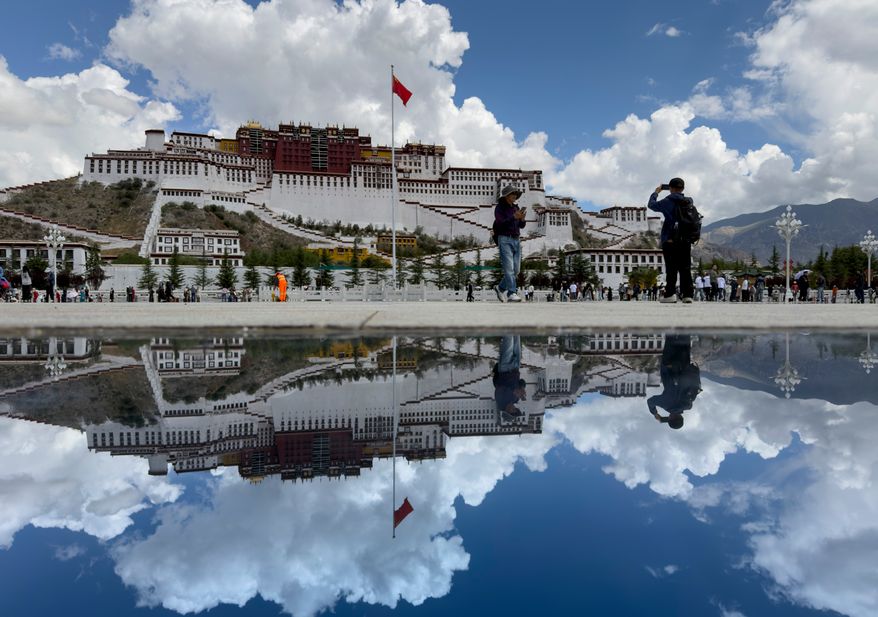 The Potala Palace is reflected off a polished tile on a square in Lhasa in western China's Tibet Autonomous Region on Tuesday, July 21, 2026, as seen during a government organized visit for foreign journalists. (AP Photo/Ng Han Guan)