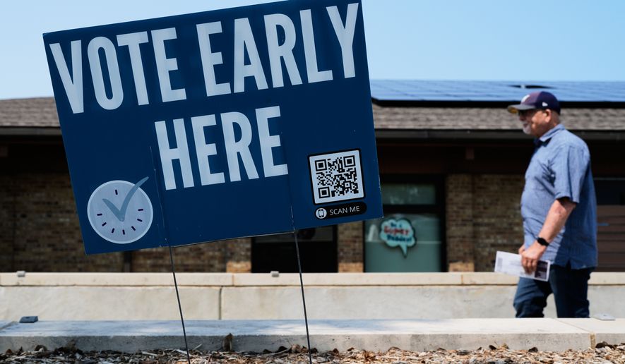 A voter walks to polling place in Milwaukee, Tuesday, July 28, 2026. (AP Photo/Nam Y. Huh)