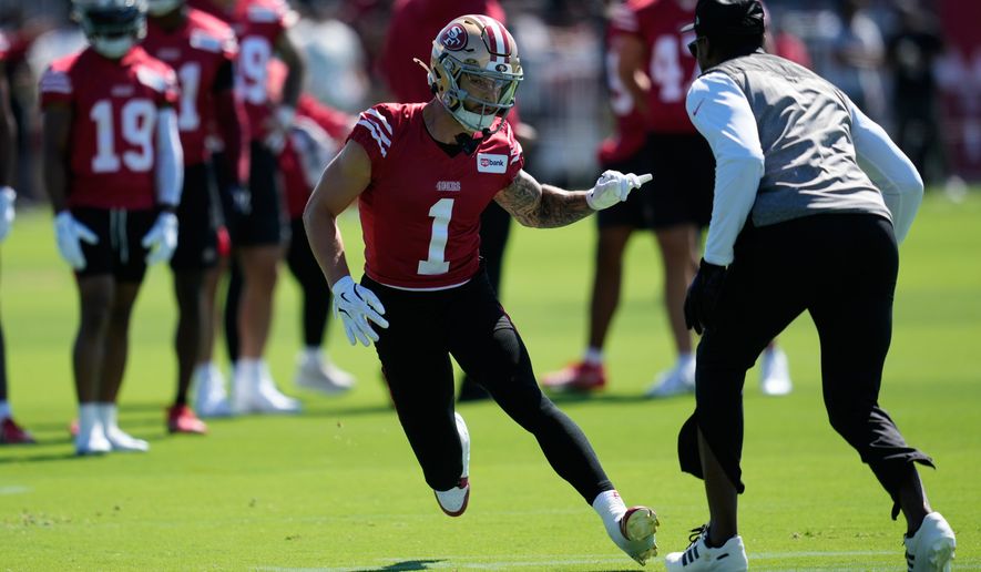 San Francisco 49ers wide receiver Ricky Pearsall (1) runs a drill against wide receivers coach Leonard Hankerson during the NFL football team's training camp Monday, July 27, 2026, in Santa Clara, Calif. (AP Photo/Jeff Chiu)