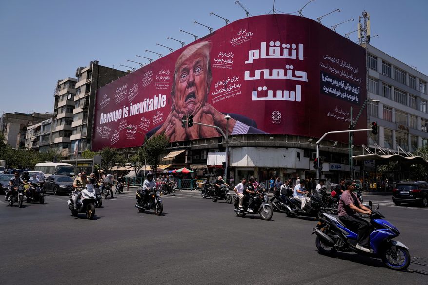 Motorcyclists ride past a billboard depicting U.S. President Donald Trump with hands around his neck alongside the message "Revenge is inevitable" in English and Farsi, in Tehran, Iran, Monday, July 27, 2026. (AP Photo/Vahid Salemi)