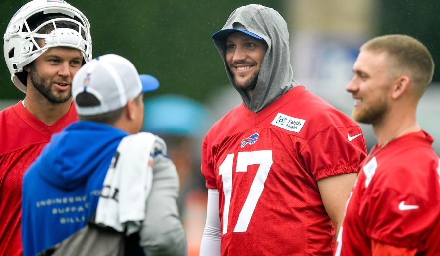 Buffalo Bills quarterback Josh Allen, center, talks with quarterbacks Kyle Allen, left, and Shane Buechele, right, before practice at the team's NFL football training camp Wednesday, July 29, 2026, in Pittsford, N.Y. (AP Photo/Adrian Kraus)