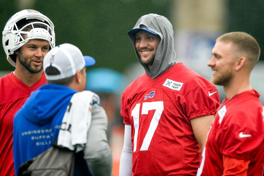 Buffalo Bills quarterback Josh Allen, center, talks with quarterbacks Kyle Allen, left, and Shane Buechele, right, before practice at the team's NFL football training camp Wednesday, July 29, 2026, in Pittsford, N.Y. (AP Photo/Adrian Kraus)