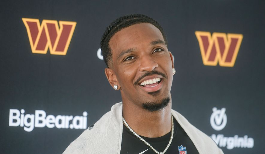 Washington Commanders quarterback Jayden Daniels (5) talks to reporters following practice at the team's NFL football training camp, Wednesday, July 29, 2026, in Ashburn, Va. (AP Photo/Rod Lamkey, Jr.)