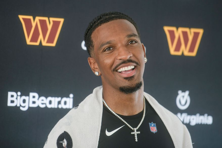 Washington Commanders quarterback Jayden Daniels (5) talks to reporters following practice at the team's NFL football training camp, Wednesday, July 29, 2026, in Ashburn, Va. (AP Photo/Rod Lamkey, Jr.)
