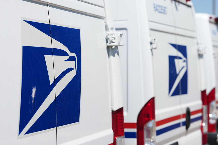 Delivery vans bearing the logo sit during a protest staged as part of a countrywide National Day of Action Tuesday, July 28, 2026, outside the main United States Postal Service headquarters in northeast Denver. (AP Photo/David Zalubowski)