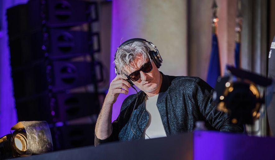 FILE - French Vincent Belorgey, known as Kavinsky, performs during the 'Fete de la Musique', the music day celebration in the courtyard of the Elysee Palace, in Paris, Thursday, 21 June 2018. (Christophe Petit Tesson, Pool via AP, FILE)