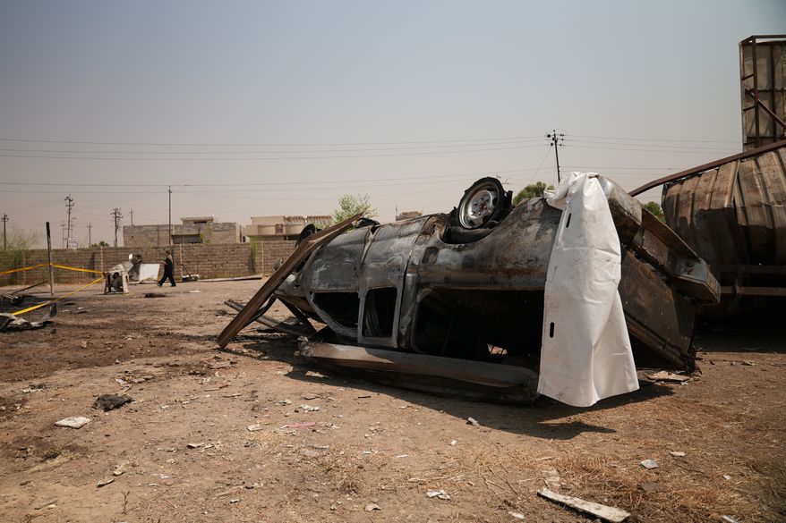 A damaged vehicle at the site of an airstrike on a Popular Mobilization Forces base in Mosul, Iraq, Wednesday, July 29, 2026. (AP Photo/Farid Abdulwahed)