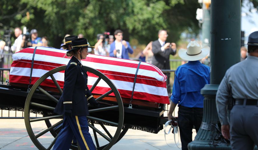 The flag-draped casket of U.S. Sen. Lindsey Graham, R-S.C., is carried on a horse-drawn caisson to his funeral at First Baptist Church in Columbia, S.C., on Wednesday, July 29, 2026. (AP Photo/Jeffrey Collins).