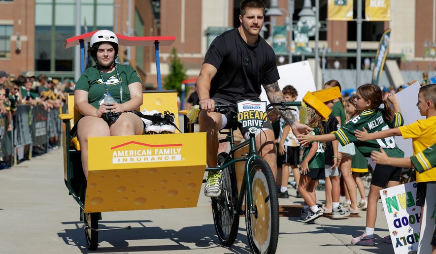 Green Bay Packers tight end Tucker Kraft rides a bike to practice at the team's NFL football training camp, Wednesday, July 29, 2026, in Green Bay, Wis. (AP Photo/Matt Ludtke)