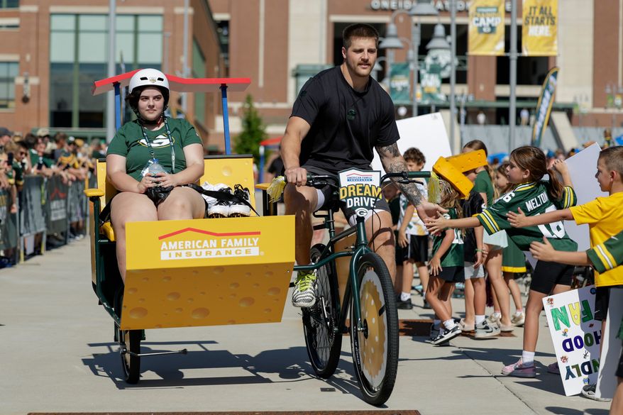 Green Bay Packers tight end Tucker Kraft rides a bike to practice at the team's NFL football training camp, Wednesday, July 29, 2026, in Green Bay, Wis. (AP Photo/Matt Ludtke)