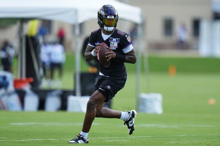 Baltimore Ravens quarterback Lamar Jackson (8) works out during practice at the team's NFL football training camp, Wednesday, July 29, 2026, at the Under Armour Performance Center in Owings Mills, Md. (AP Photo/Stephanie Scarbrough)