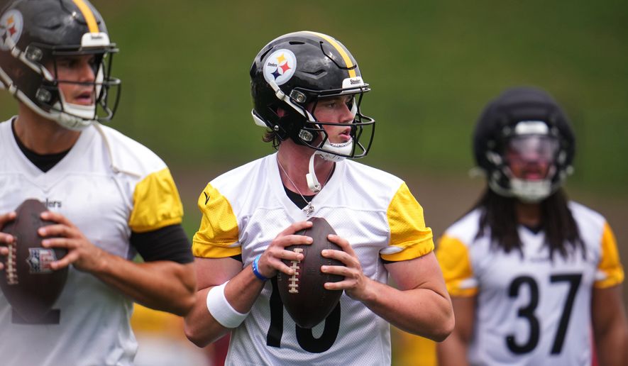 Pittsburgh Steelers quarterbacks Mason Rudolph, left, and Drew Allar, center, works out during practice at the team's NFL football training camp in Latrobe, Pa., Wednesday, July 29, 2026. (AP Photo/Gene J. Puskar)