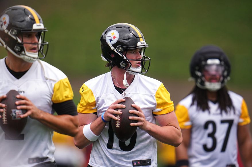 Pittsburgh Steelers quarterbacks Mason Rudolph, left, and Drew Allar, center, works out during practice at the team's NFL football training camp in Latrobe, Pa., Wednesday, July 29, 2026. (AP Photo/Gene J. Puskar)