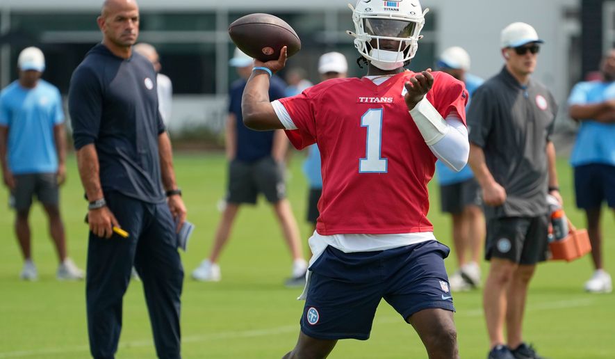 Tennessee Titans quarterback Cam Ward (1) looks to throw a pass during the NFL football team's training camp Wednesday, July 29, 2026, in Nashville, Tenn. (AP Photo/George Walker IV)