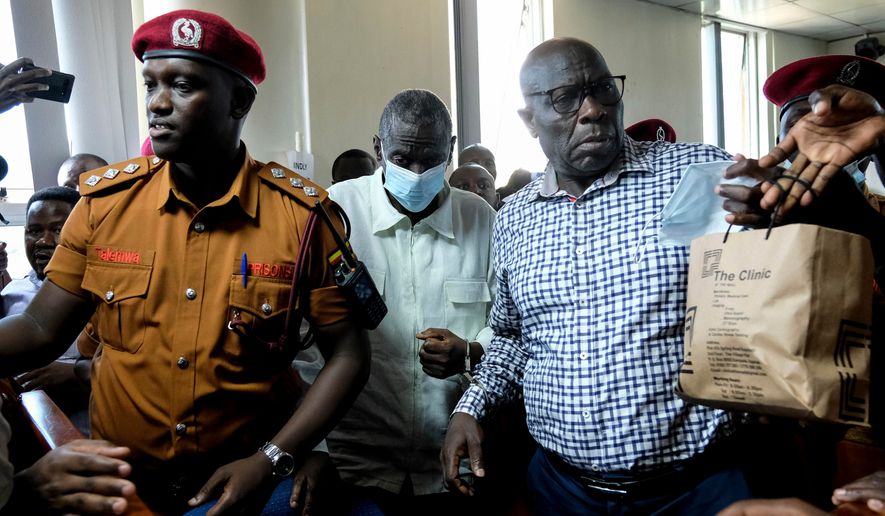 FILE - Ugandan opposition leader and four-time presidential candidate Kizza Besigye, second left centre, arrives in a civilian court in Kampala, Uganda on Feb. 19, 2025. (AP Photo/Hajarah Nalwadda)