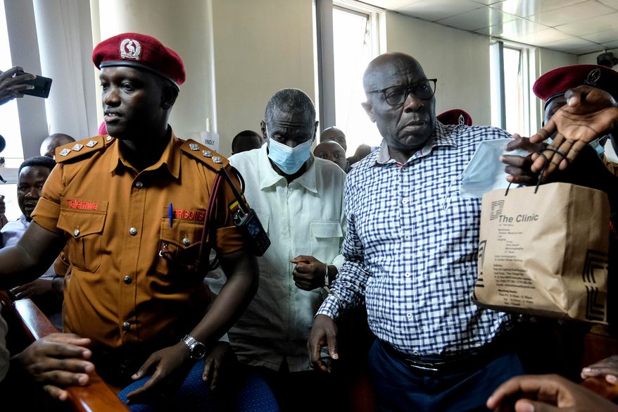 FILE - Ugandan opposition leader and four-time presidential candidate Kizza Besigye, second left centre, arrives in a civilian court in Kampala, Uganda on Feb. 19, 2025. (AP Photo/Hajarah Nalwadda)
