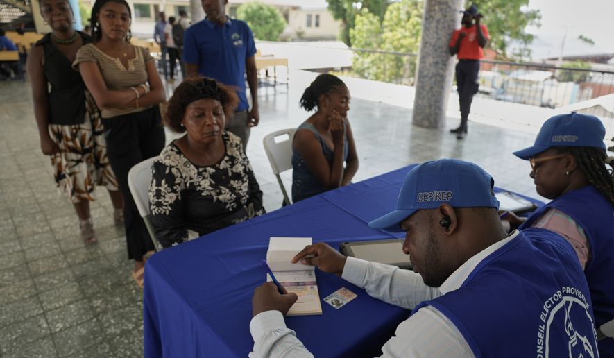 Haitians register to vote in the upcoming general election in Port-au-Prince, Haiti, Thursday, July 30, 2026. (AP Photo/Odelyn Joseph)