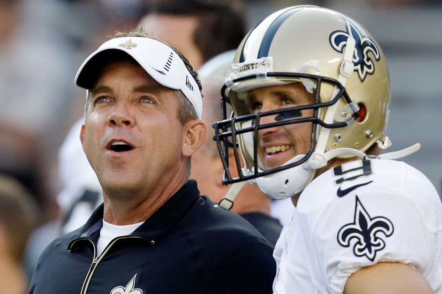FILE - New Orleans Saints head coach Sean Payton talks to quarterback Drew Brees before a preseason NFL football game against the Green Bay Packers, Sept. 3, 2015, in Green Bay, Wis. (AP Photo/Jeffrey Phelps, File)