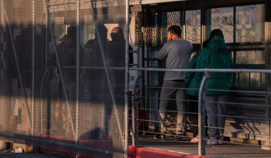 FILE - A group of undocumented migrants is deported by U.S. Immigration and Customs Enforcement agents across the McAllen–Hidalgo–Reynosa International Bridge in McAllen, Texas, March 13, 2026. (AP Photo/Felix Marquez, File)