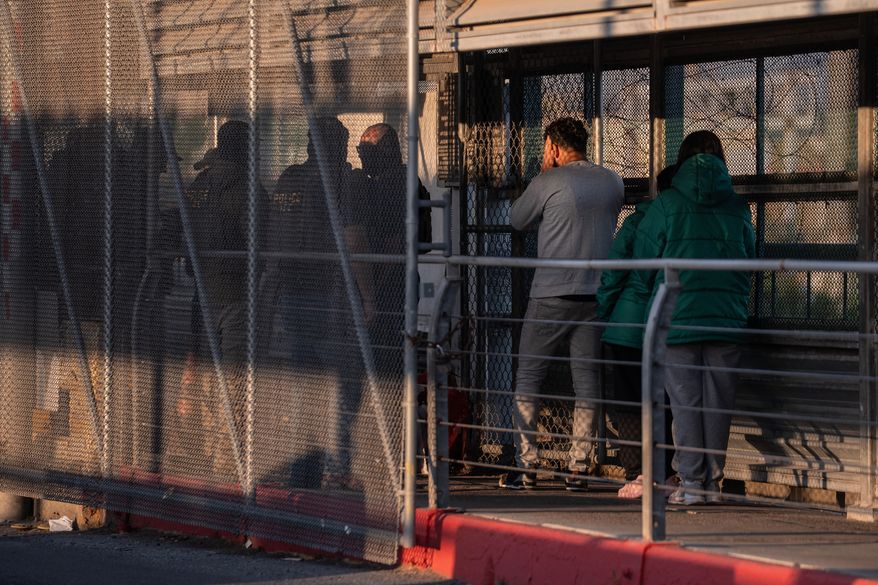 FILE - A group of undocumented migrants is deported by U.S. Immigration and Customs Enforcement agents across the McAllen–Hidalgo–Reynosa International Bridge in McAllen, Texas, March 13, 2026. (AP Photo/Felix Marquez, File)