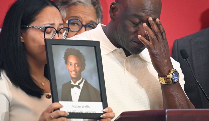 Elmore Wonsley, right, pauses from speaking as wife Christine Wonsley holds a photo of her deceased son, Nolan Wells, as they appear at the National Urban League's annual conference, Thursday, July 30, 2026, in Nashville, Tenn. (AP Photo/John Amis)