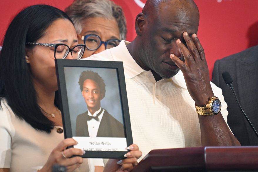 Elmore Wonsley, right, pauses from speaking as wife Christine Wonsley holds a photo of her deceased son, Nolan Wells, as they appear at the National Urban League's annual conference, Thursday, July 30, 2026, in Nashville, Tenn. (AP Photo/John Amis)