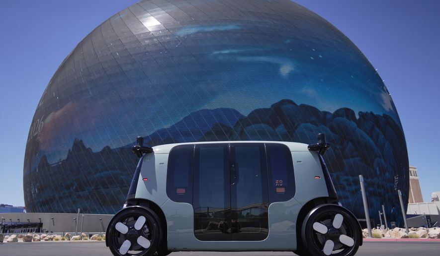An Amazon Zoox taxi with no steering wheel drives in front of The Sphere on the Las Vegas strip, Thursday, July 30, 2026. (AP Photo/Ty ONeil)