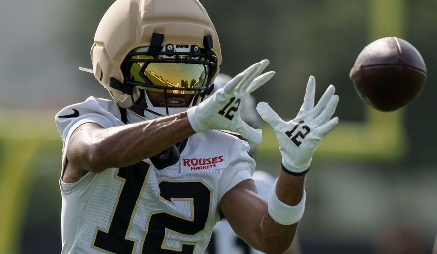 New Orleans Saints wide receiver Chris Olave (12) makes a catch during practice at the team's NFL football training camp in Metairie, La., Wednesday, July 29, 2026. (AP Photo/Matthew Hinton)