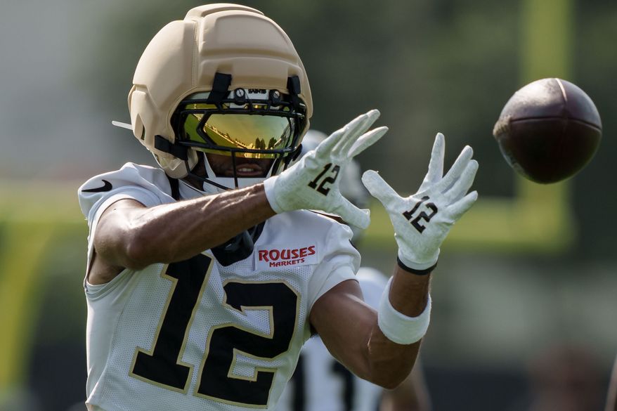 New Orleans Saints wide receiver Chris Olave (12) makes a catch during practice at the team's NFL football training camp in Metairie, La., Wednesday, July 29, 2026. (AP Photo/Matthew Hinton)