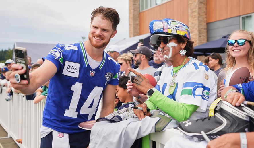 Seattle Seahawks quarterback Sam Darnold takes a selfie during the NFL football team's training camp, Sunday, July 26, 2026, in Renton, Wash. (AP Photo/Lindsey Wasson)