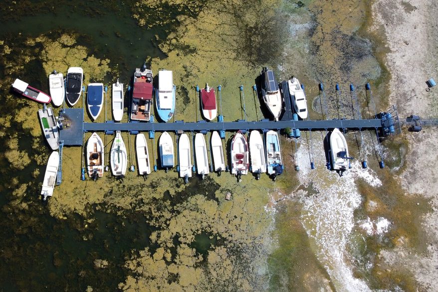 Boats sit on dry ground as water levels have dropped on the Danube River in Novi Sad, Serbia, Wednesday, July 29, 2026. (AP Photo/Darko Vojinovic)