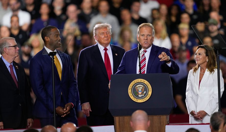 Republican Senate candidate Mike Rogers speaks as Rep. Tim Walberg, R-Mich., Rep. John James, R-Mich., President Donald Trump and Rep. Lisa McClain, R-Mich., listen at an event at the General Motors Proving Ground Monday, July 27, 2026, in Milford, Mich. (AP Photo/Paul Sancya) ** FILE **