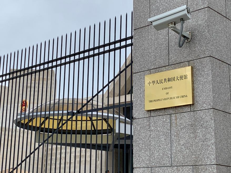EMBASSY OF THE PEOPLE’S REPUBLIC OF CHINA - PRC - sign at embassy gate, WASHINGTON, DC - MAY 4, 2019: Photo credit: DCStockPhotography via Shutterstock.